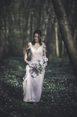 Bride walking bare foot through the woods