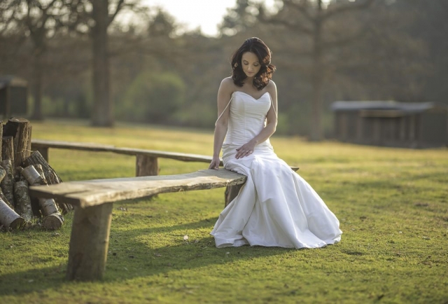 Bride sitting on a bench at the Dreys