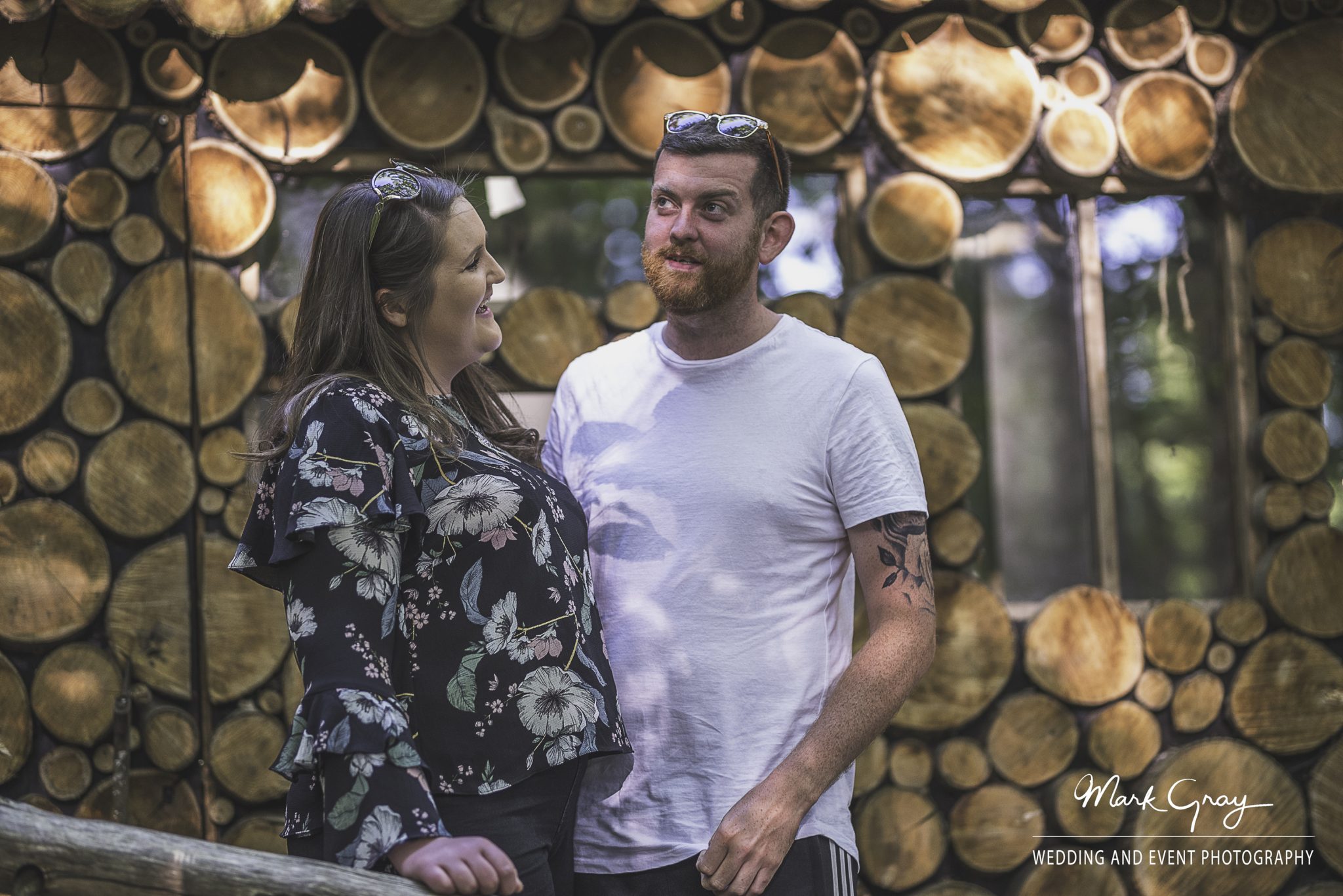 Engaged couple outside the woodcutters hut at the Dreys wedding and event venue