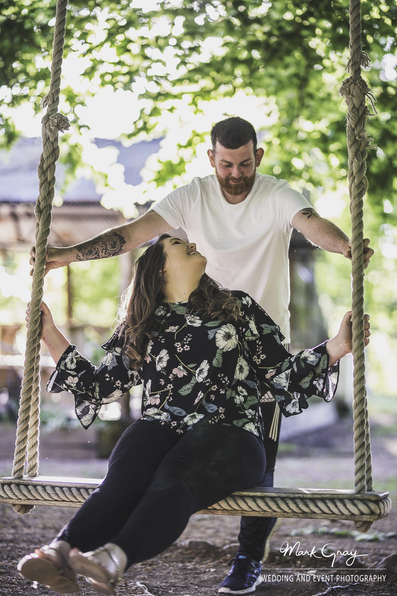 Engaged couple on the swing at the Dreys wedding and event venue