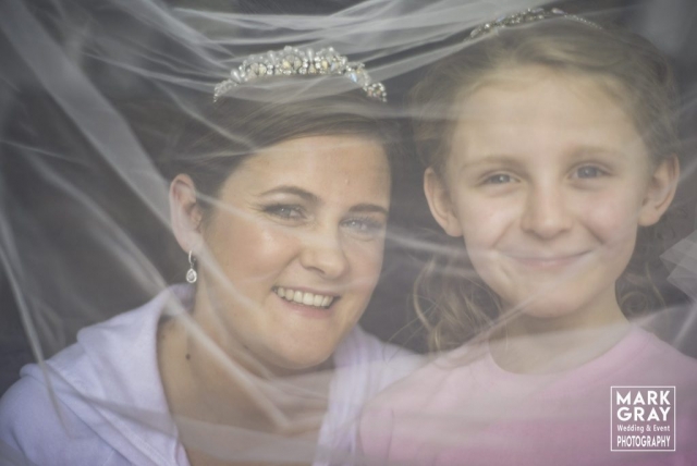 Bride and daughter under the veil
