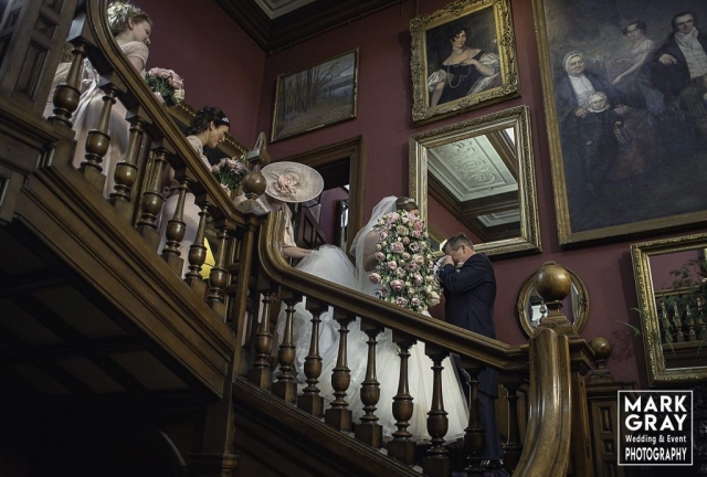 Dad meets the bride on the stairs in Chilston Park